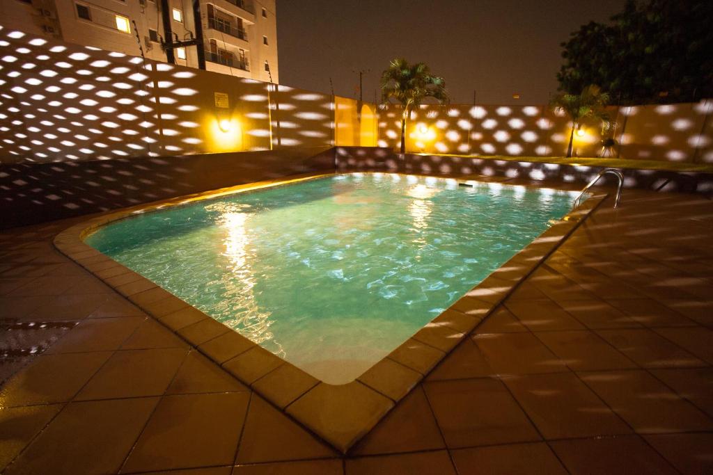 Mamle's Retreat shared pool lit up at night in Accra